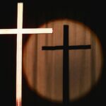 a cross with a light shining on it