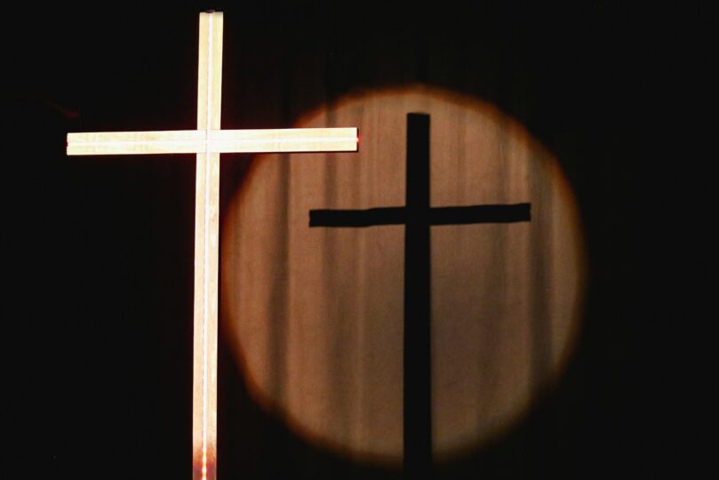 a cross with a light shining on it
